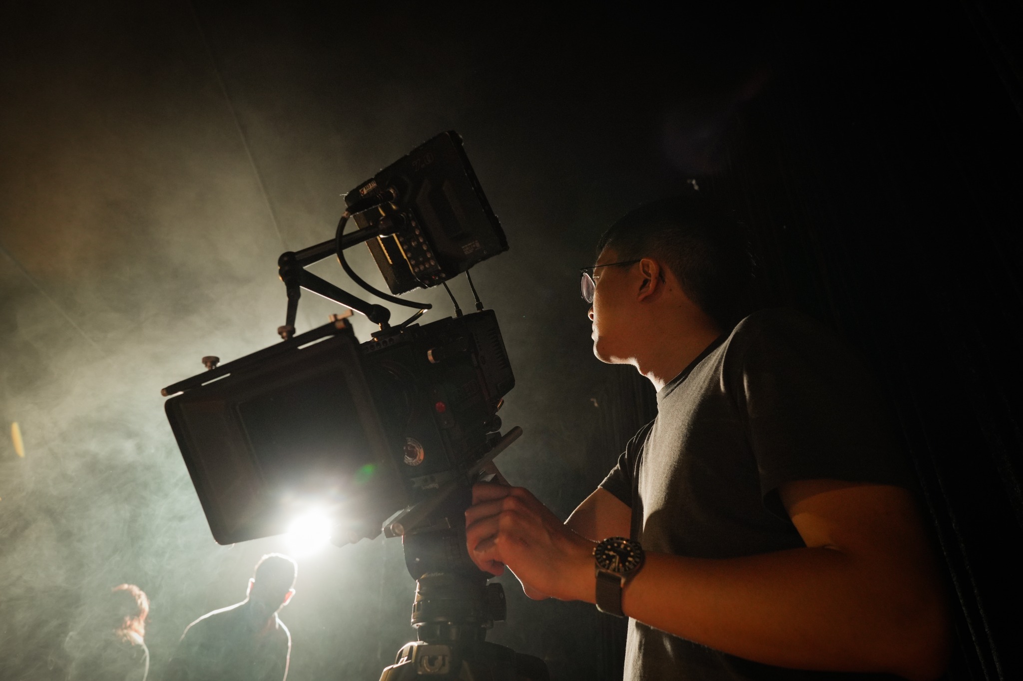 Willy operating a cinema camera on set